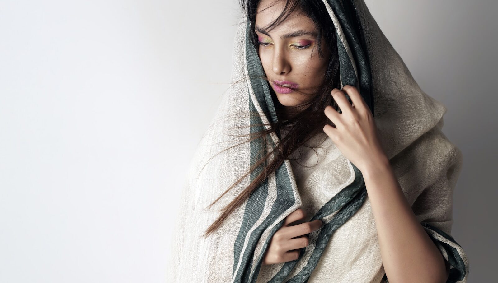 بيت a woman wrapped in a blanket with her eyes closed