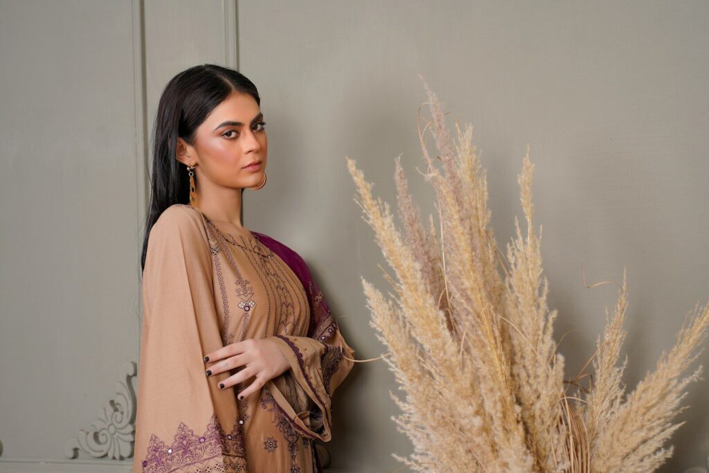 Why High-Quality Linen Is the Perfect Fabric for Summer? a woman standing next to a tall plant
