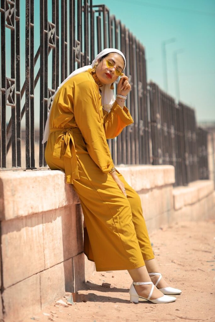 Why High-Quality Linen Is the Perfect Fabric for Summer? woman in yellow coat and pants standing on concrete stairs