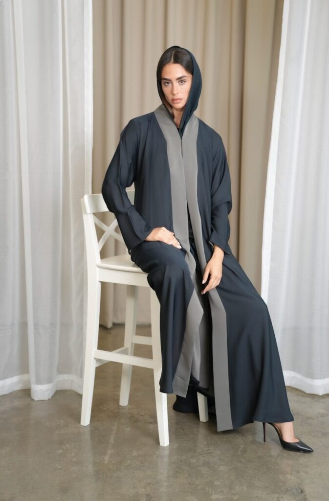 The Story Behind the NOOR Collection A woman is sitting on a chair wearing a robe